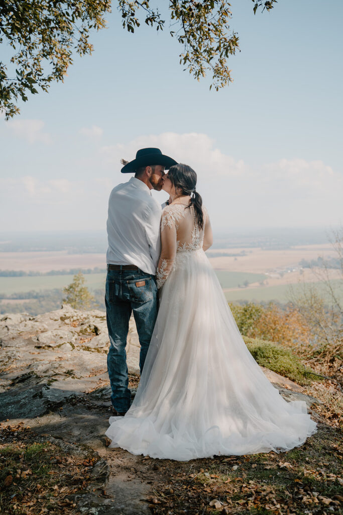 bride and groom kissing at Stout's point Petit Jean Mountain