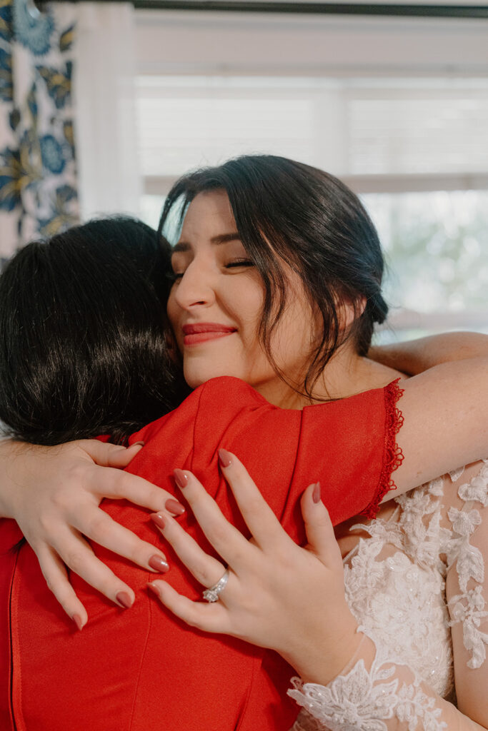 photo of bride and mother of the bride hugging before her elopement