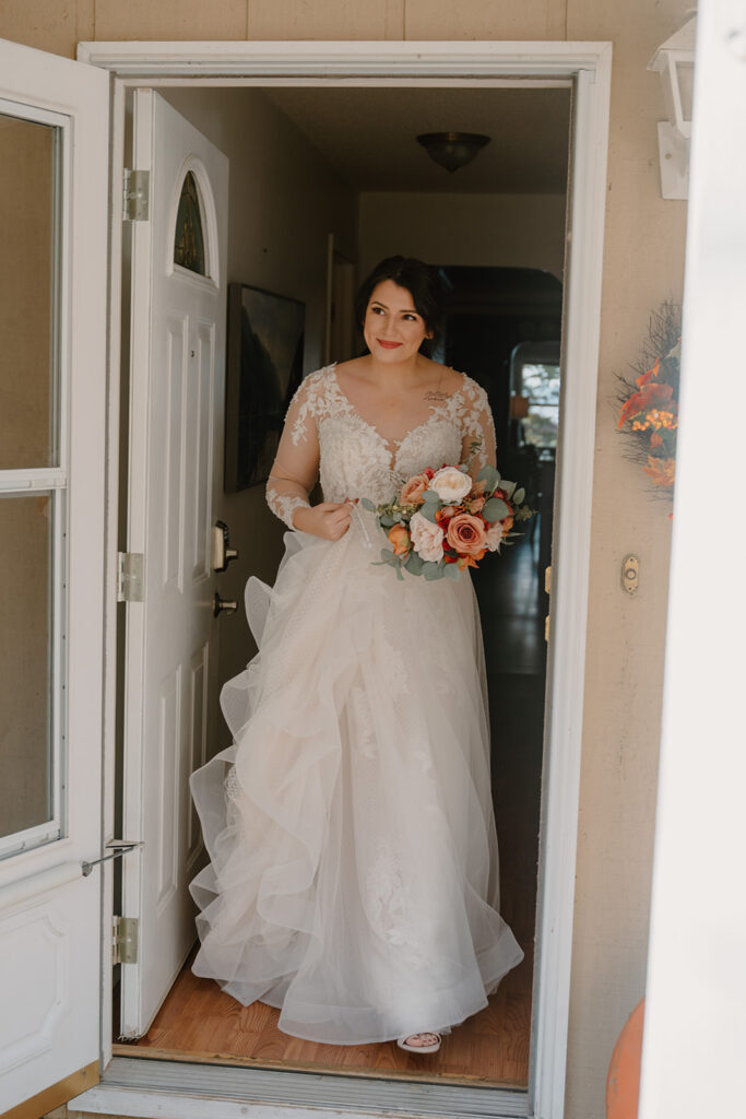 photo of bride walking out the door before her first look