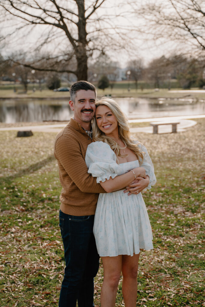 Photo of engaged couple posing in front of a pond at MacArthur Park in Little Rock, Arkansas