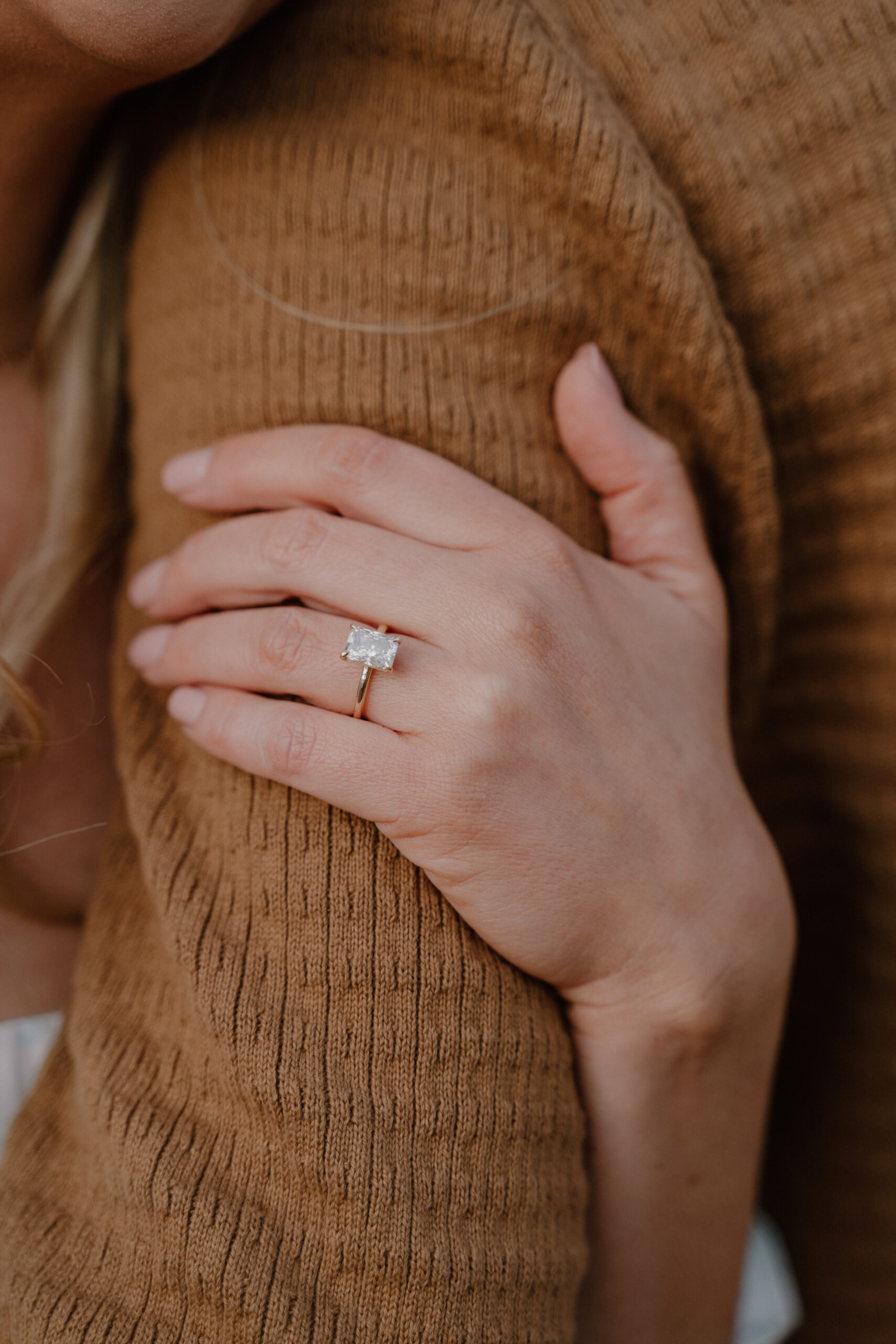 photo of engagement ring on hand