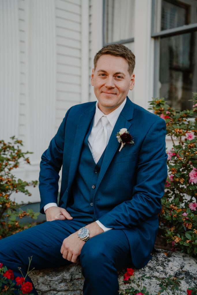 photo of groom posing sitting down looking at the camera