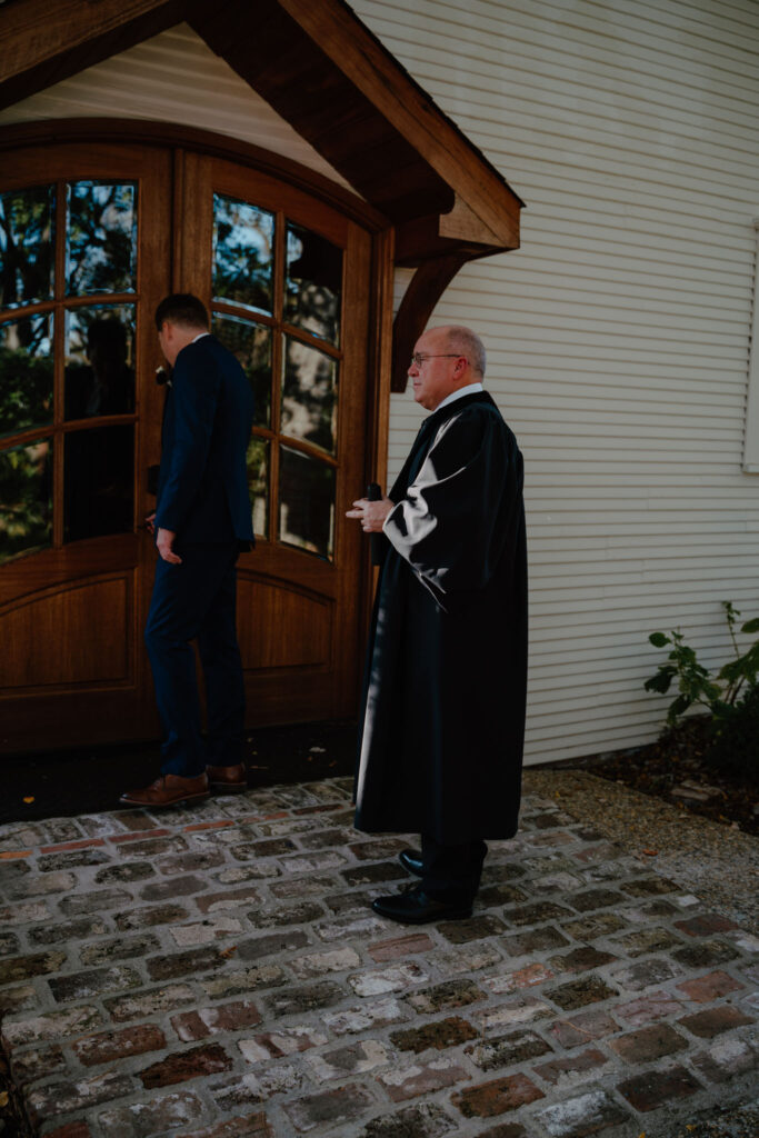 photo of groom meeting with the officiant
