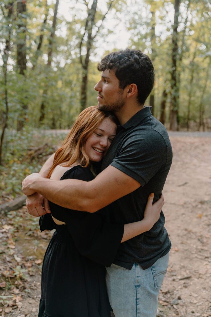 photo of couple hugging in the woods
