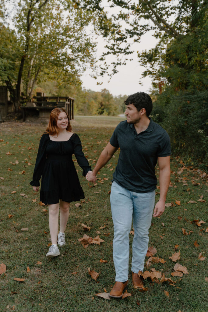 Photo of couple walking in the grass in North Little Rock