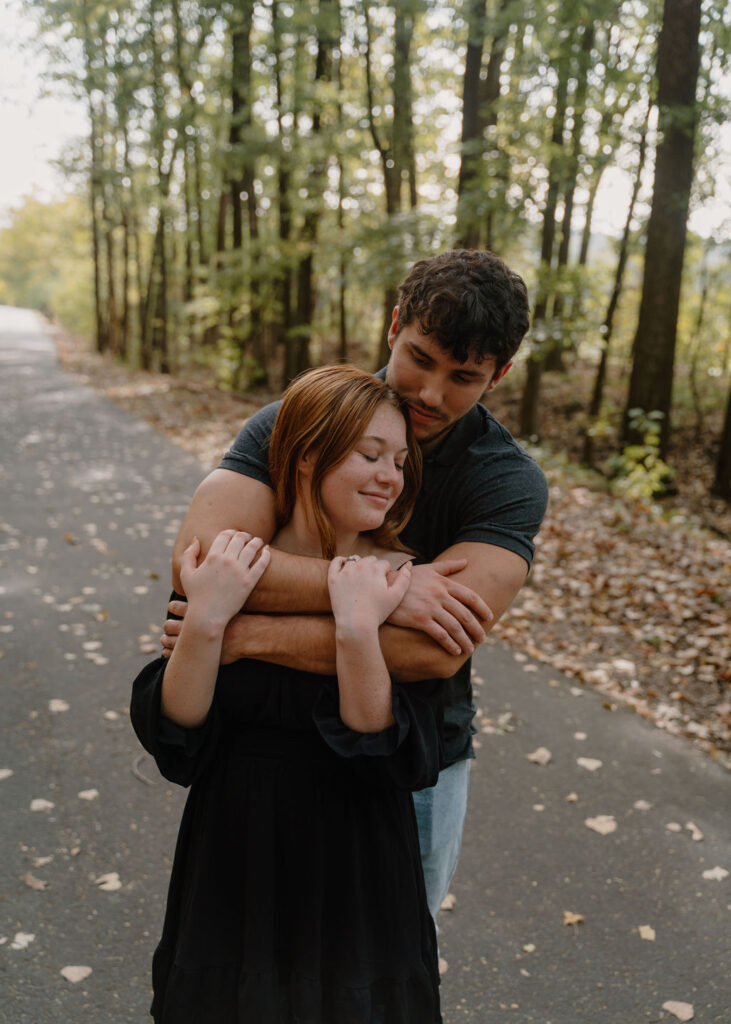 Photo of couple snuggling in the woods in North Little Rock, Arkansas
