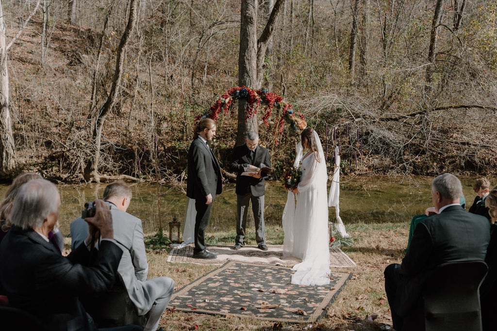 photo of bride and groom at the alter in the woods