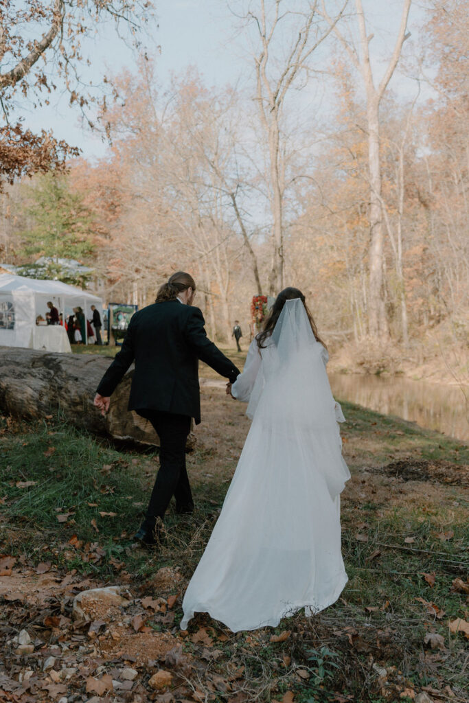 photo of bride and groom walking into their reception