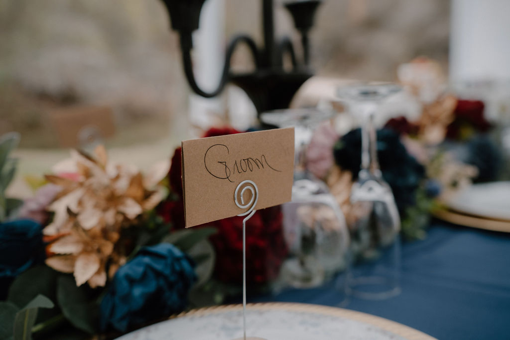 Photo of groom's place card at the reception table