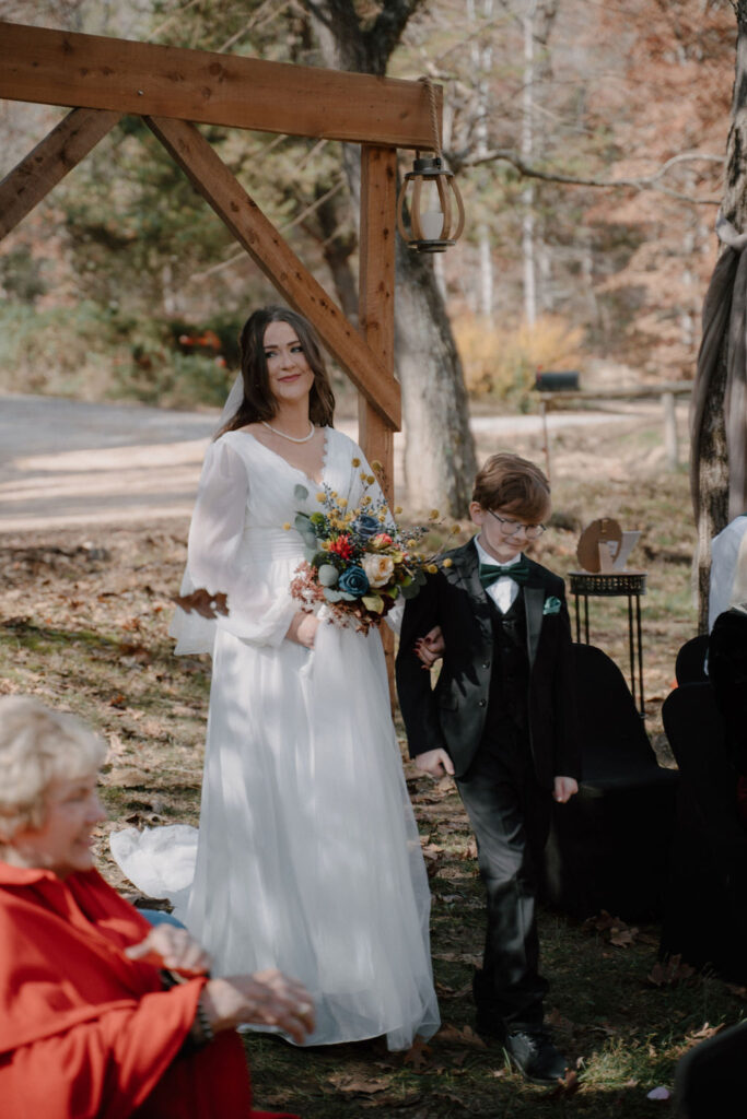 photo of bride walking down the aisle with her son