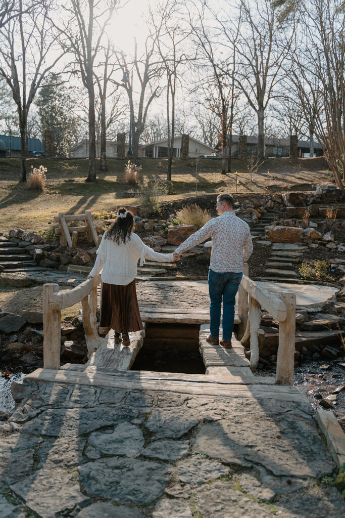 photo of engaged couple walking on a bridge at the Old Mill in North Little Rock Arkansas