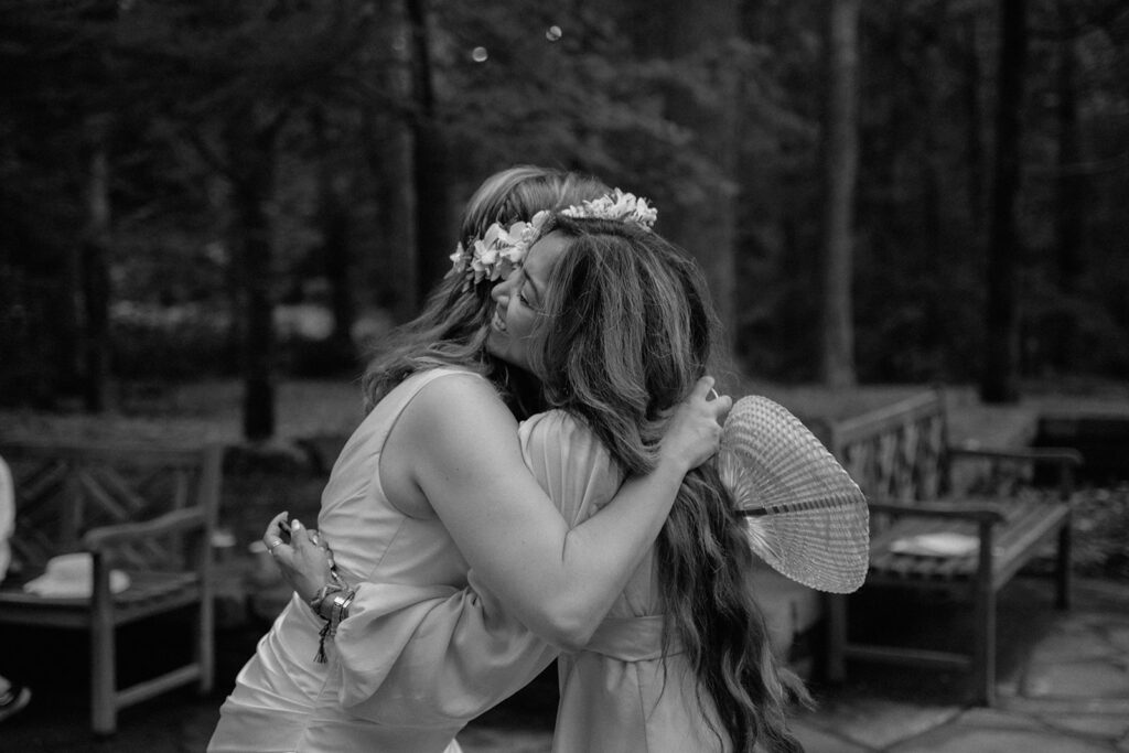 photo of bride and her friend hugging