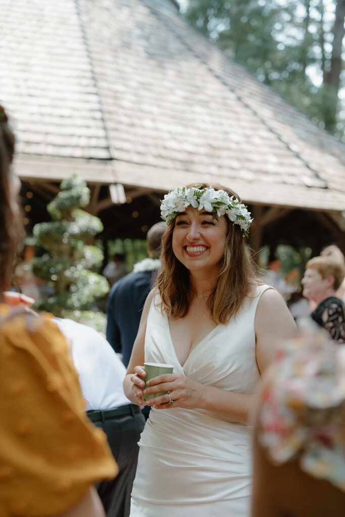 photo of bride smiling at friends during her wedding reception