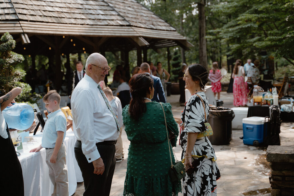 photo of the father of the bride talking with her friends