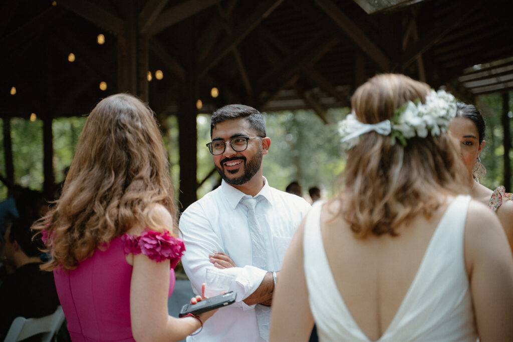 photo of friends talking at a wedding