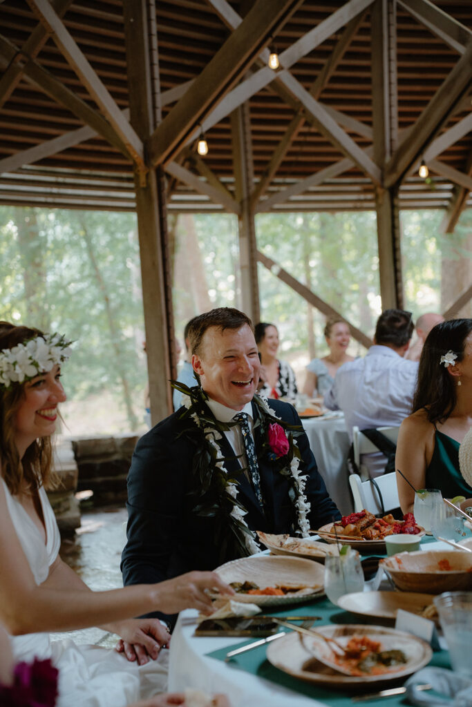 photo of groom laughing during a speech