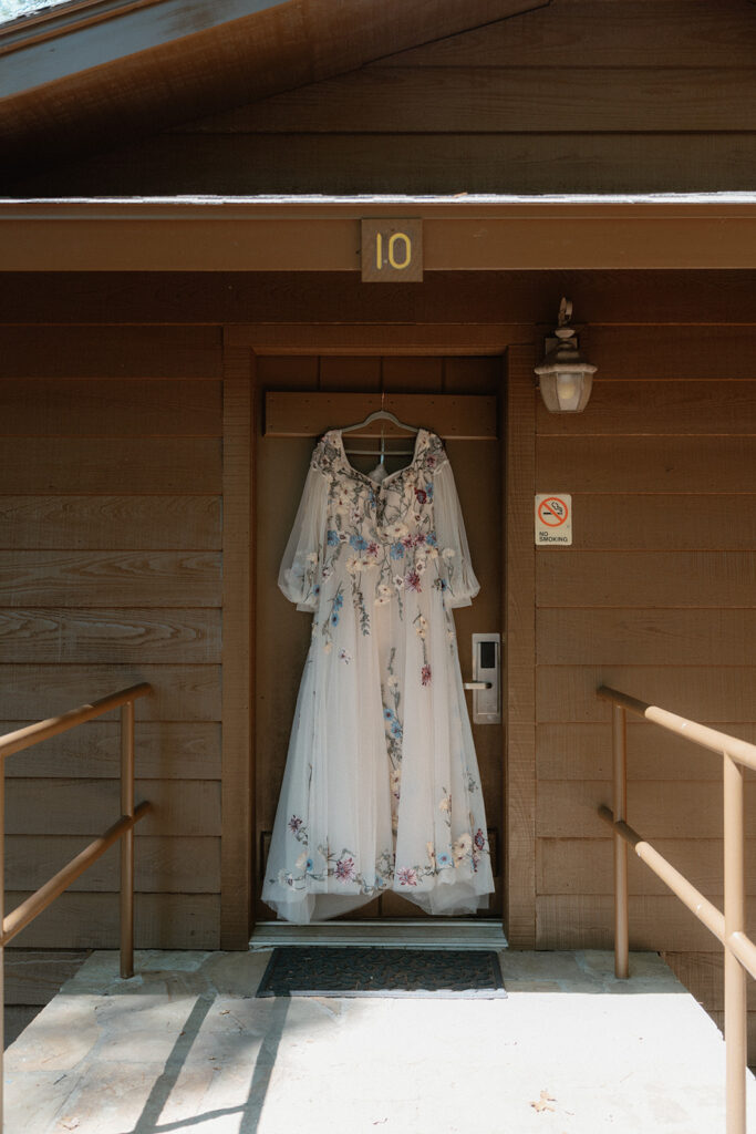 photo of wedding dress handing up at a cabin