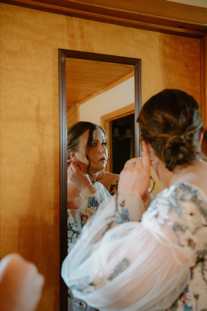 photo of bride getting ready in a mirror