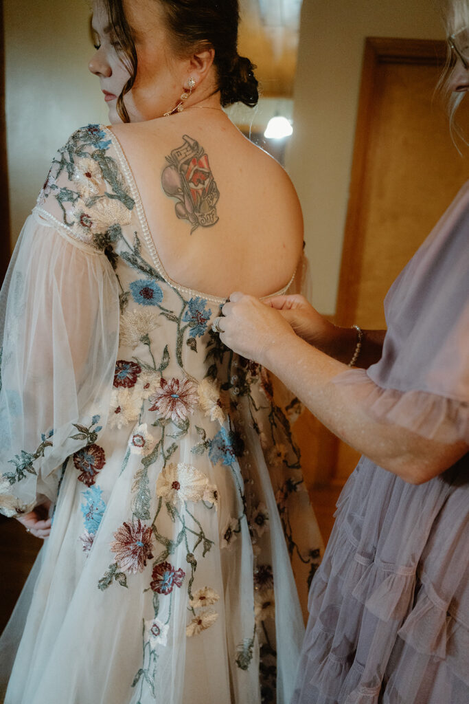 photo of mother of the bride helping the bride get ready