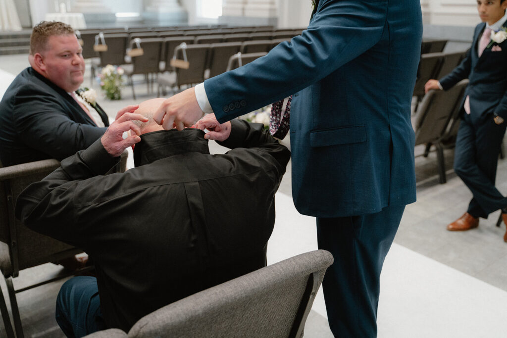 photo of groom putting father's tie on