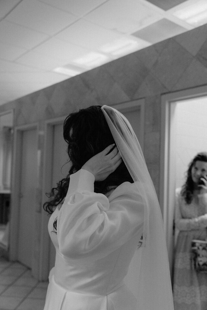 photo of bride admiring her hair