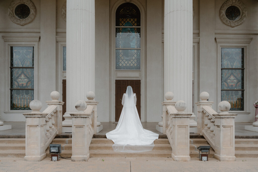 photo of bride standing in front of the venue