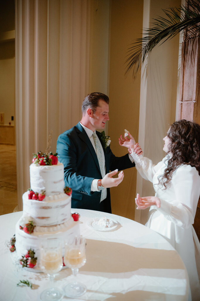 photo of bride and groom eating cake