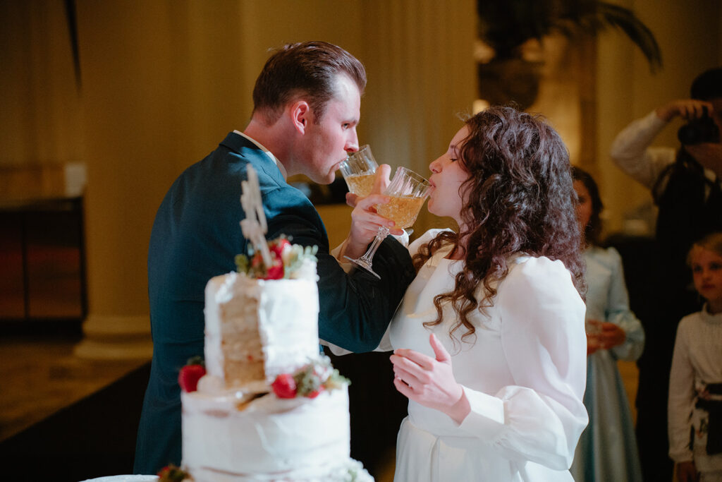 photo of wedding cake with a slice taken out of it