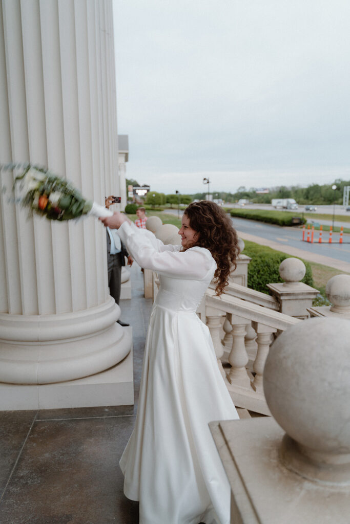 photo of bride throwing her bouquet