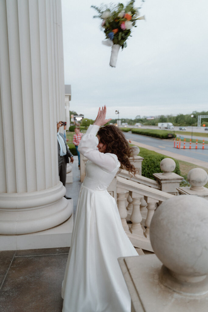 photo of bride throwing her bouquet