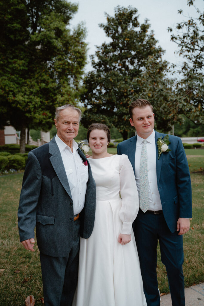 photo of bride and groom hugging her grandpa