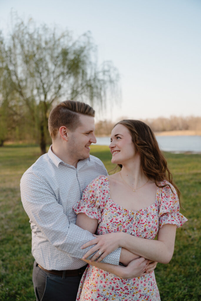 Couple posing infront of weeping willow tree during their spring engagement photoshoot