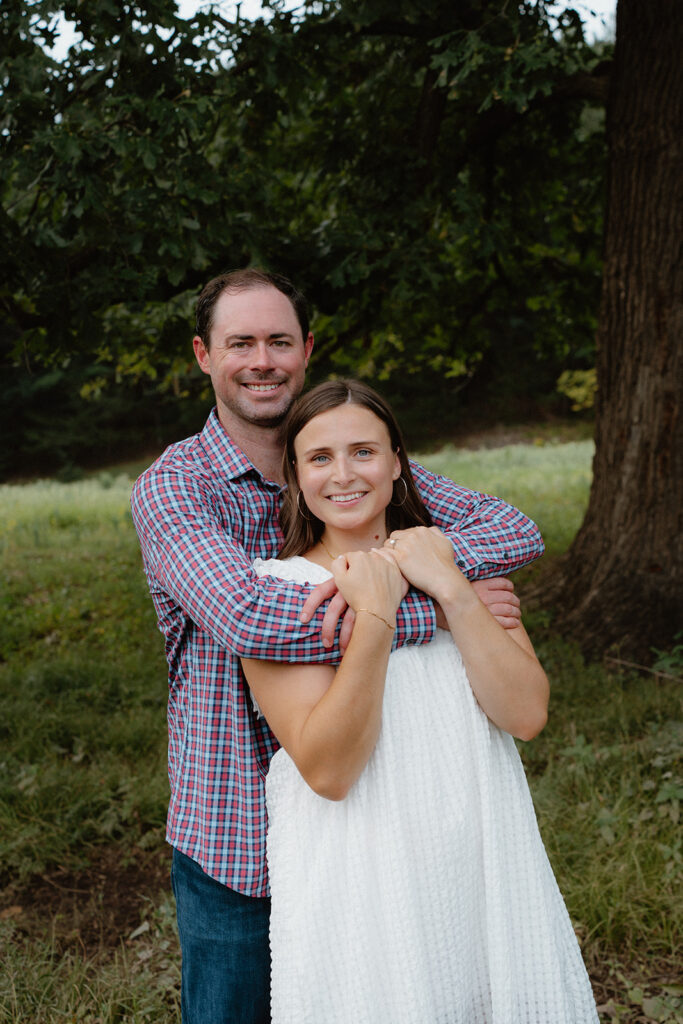 photo of engaged couple under a tree