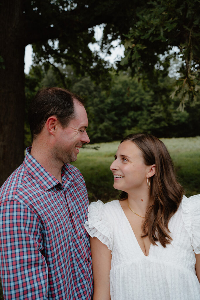 photo of engaged couple under a tree