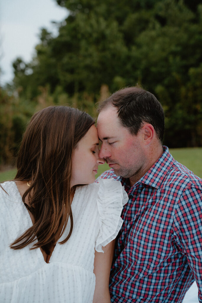 photo of engaged couple touching foreheads