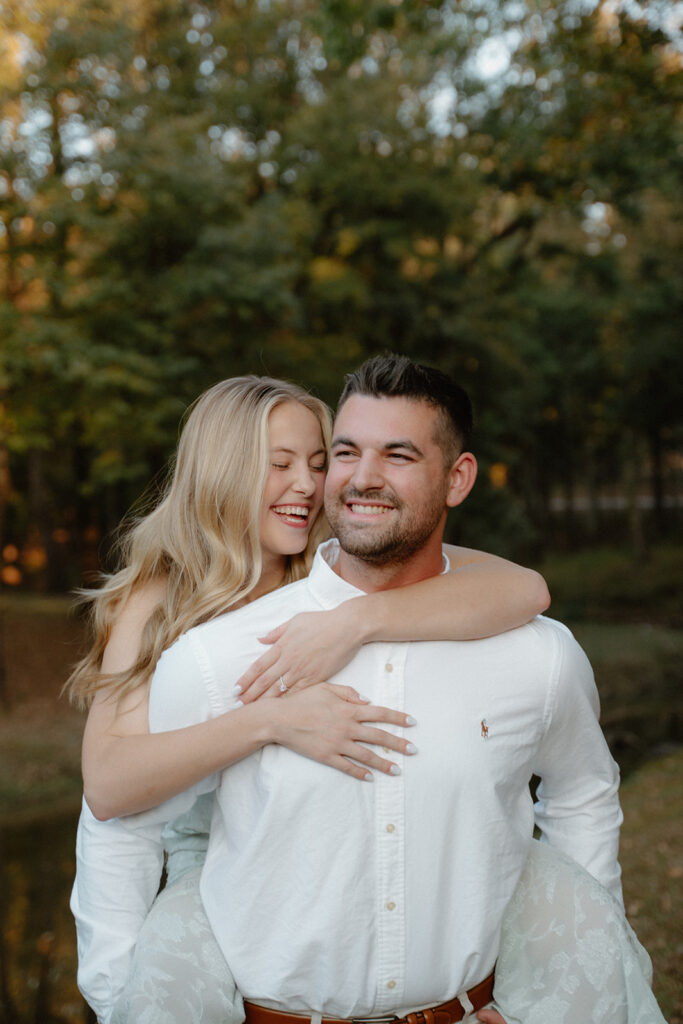 photo of engaged couple doing a piggy back pose