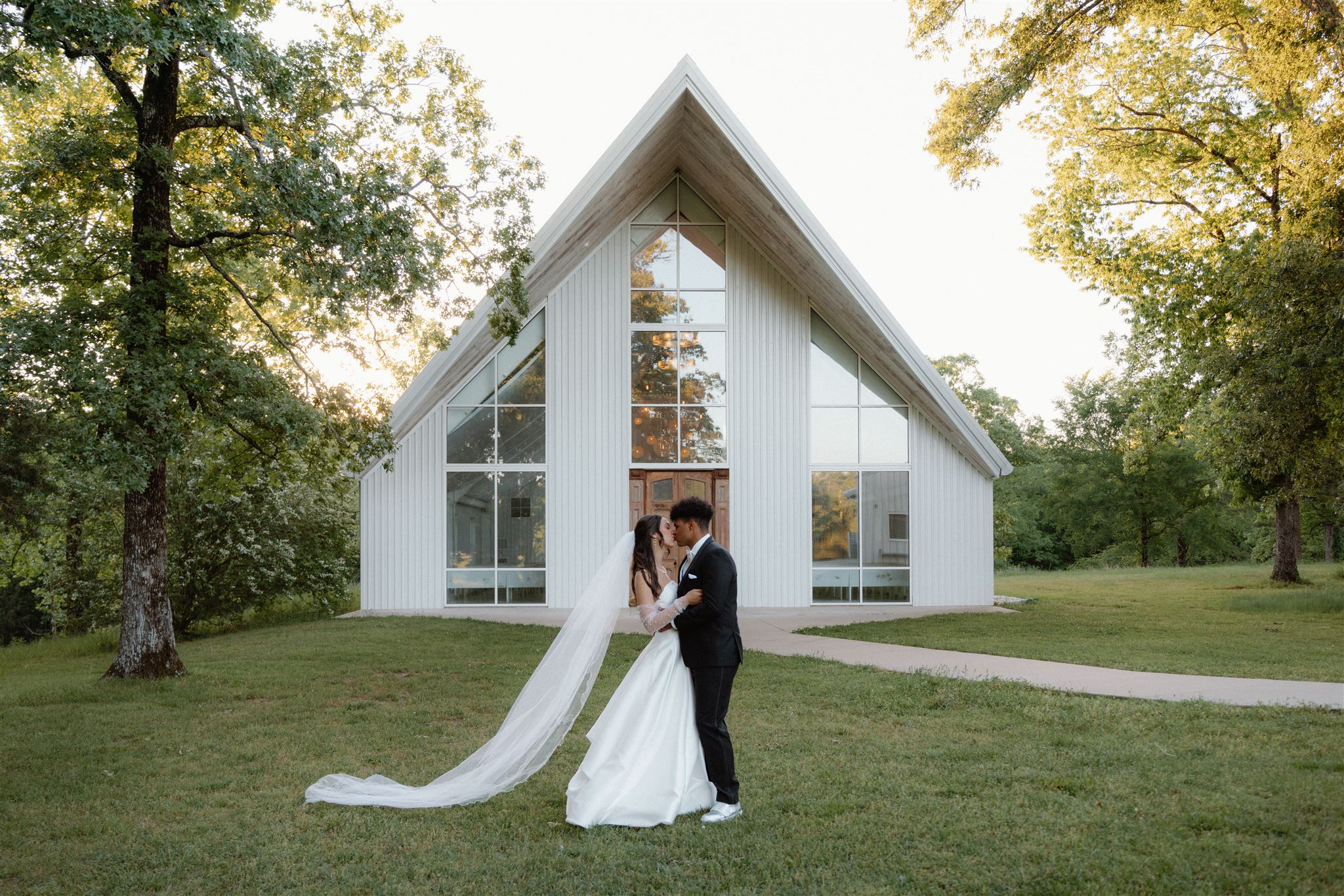 Photo of bride and groom kissing after getting married at Cold Springs in Arkansas