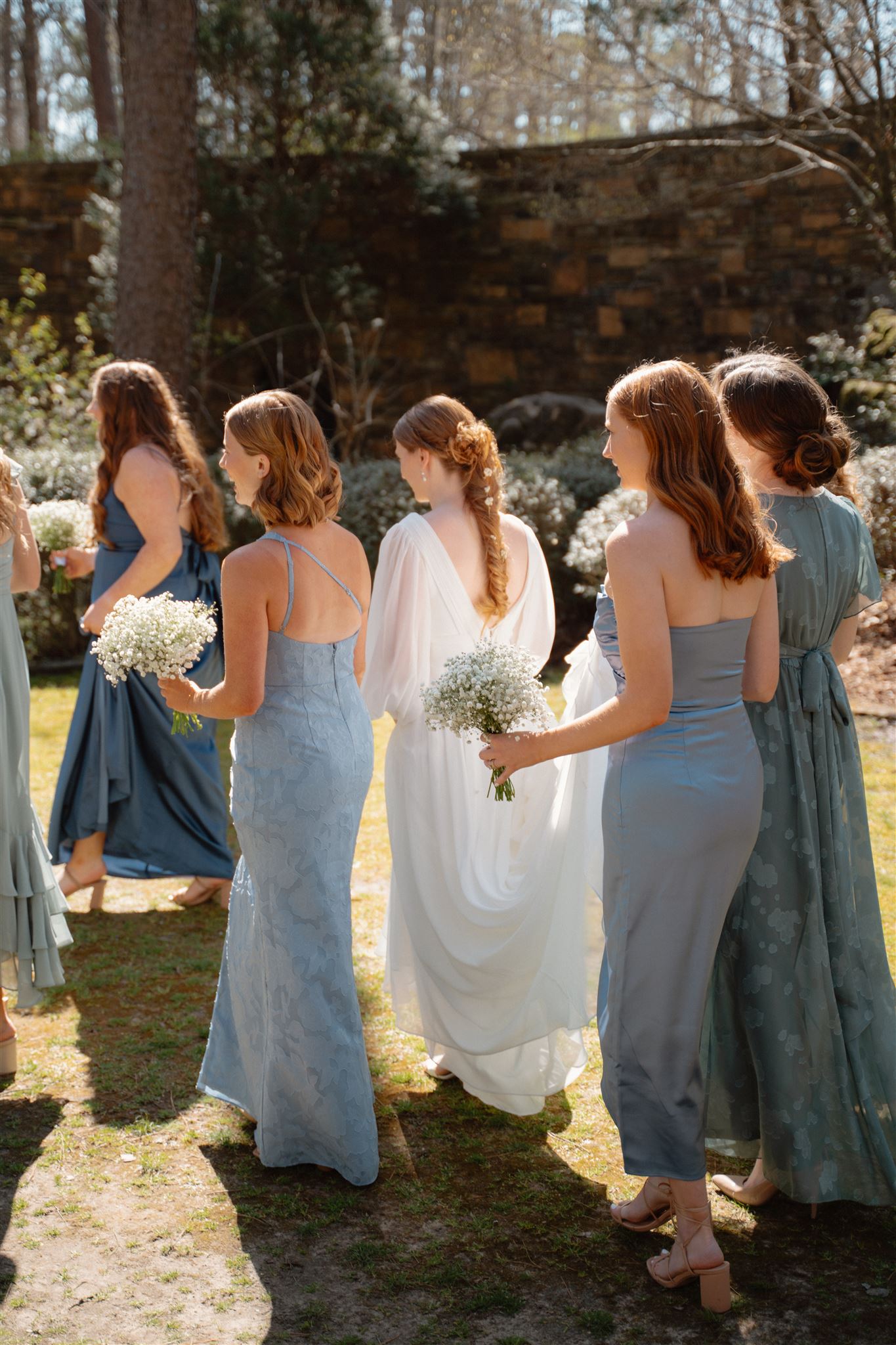 Photo of bride walking with her bridesmaids before getting married in Arkansas