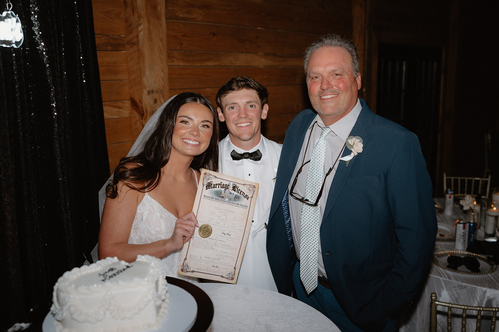 photo of bride and groom holding up their marriage license
